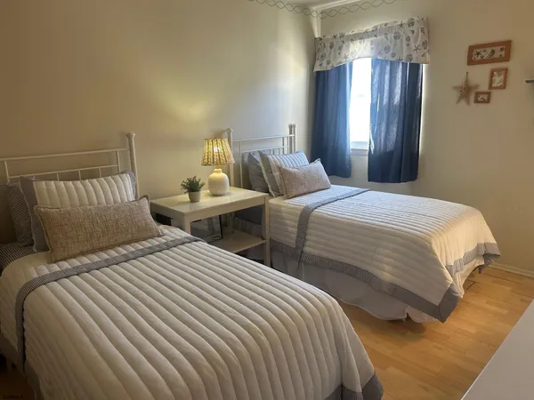 a bedroom with two beds and a chandelier