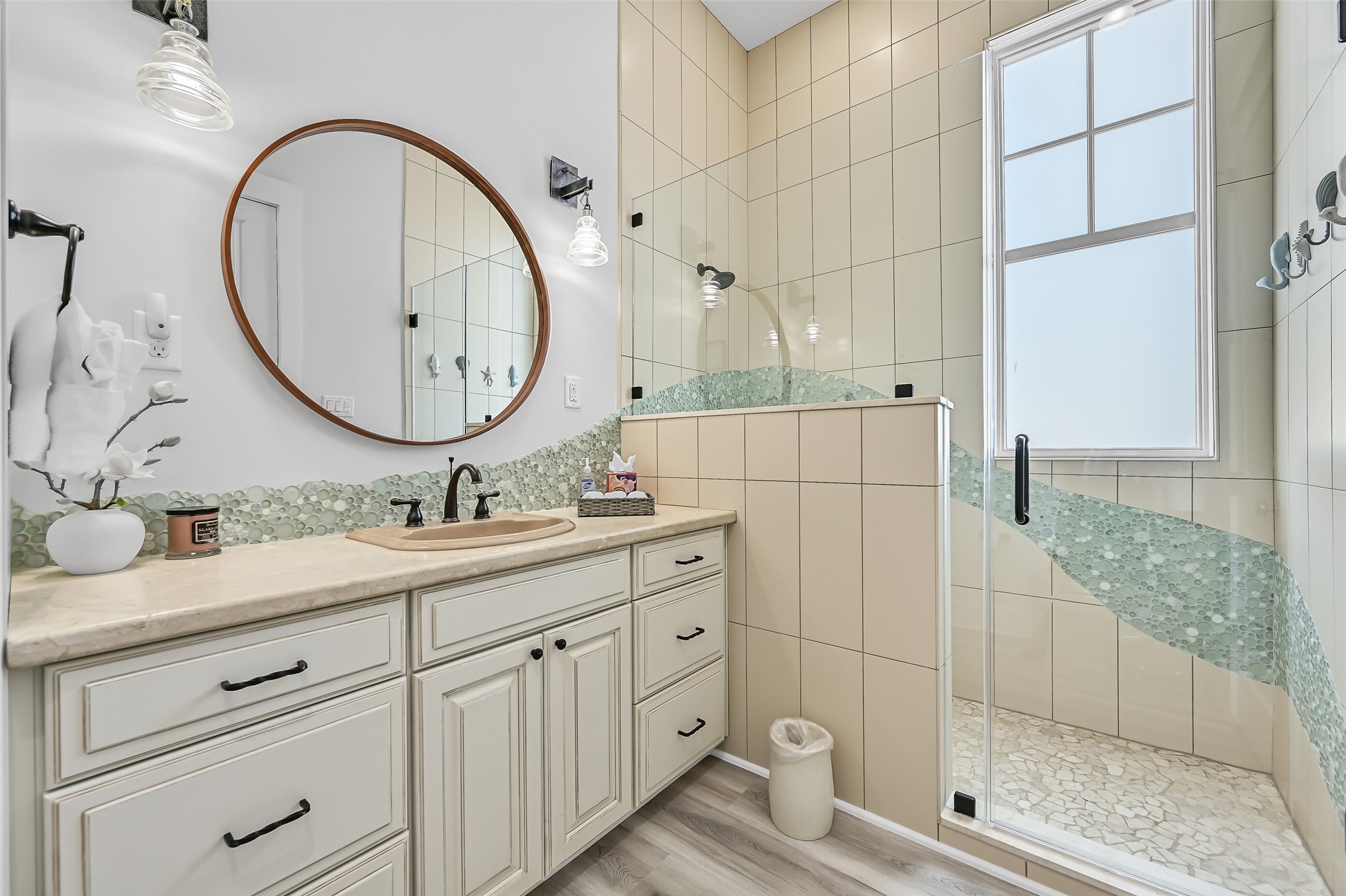 817 Positano Road Galveston, TX 77550 - Photo 34 of 50 Custom tilework, elegant fixtures, and a spacious vanity elevate this ensuite bath beyond the ordinary. Designed with both beauty and comfort in mind, it's a space that feels polished, relaxing, and effortlessly coastal.
