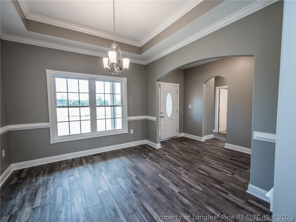 1102 West Carthage Road Lumberton, NC 28360 - Photo 16 of 41 a view of an empty room with wooden floor and a window