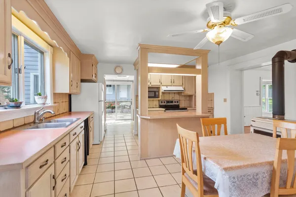 a open kitchen with stainless steel appliances granite countertop a sink and cabinets