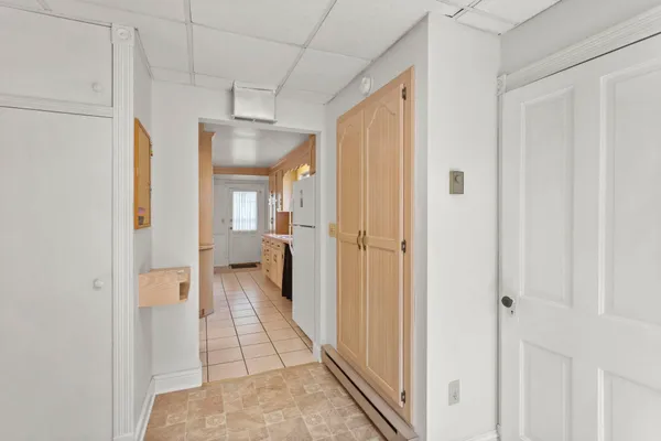 a view of a hallway with a livingroom and a bathroom