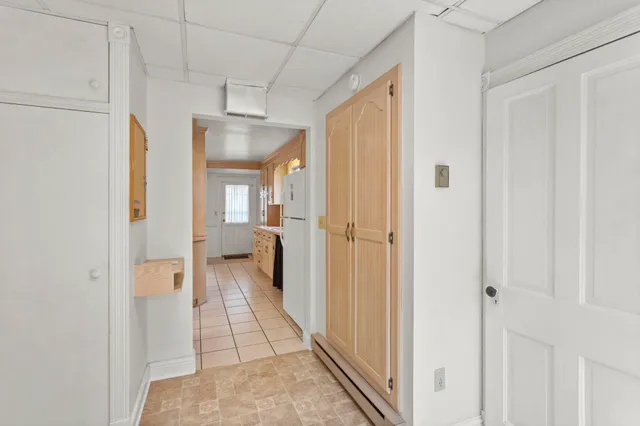 a view of a hallway with a livingroom and a bathroom