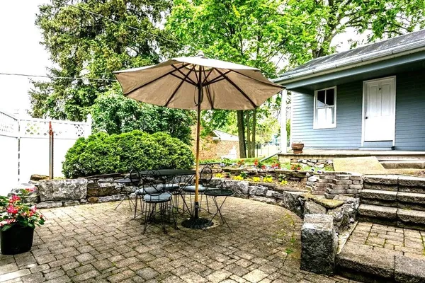 a backyard of a house with yard and outdoor seating