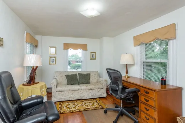 a living room with furniture a window and a lamp