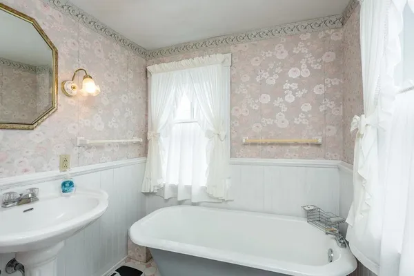 a white bath tub sitting next to a white sink