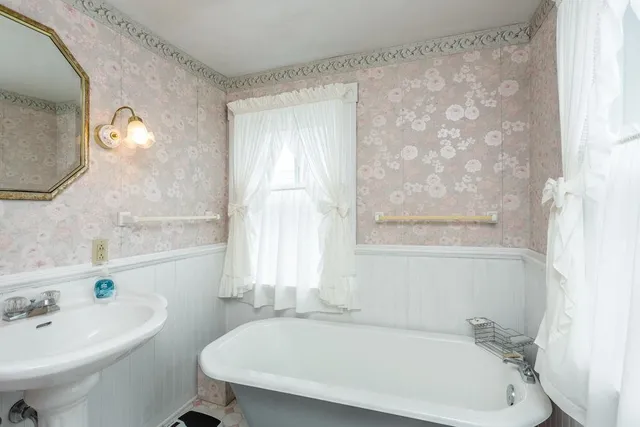 a white bath tub sitting next to a white sink