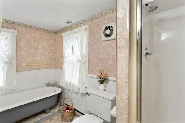 a bathroom with a tub a sink and a large mirror