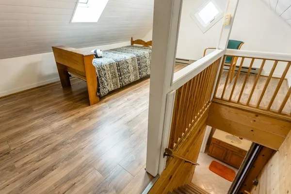 a view of a livingroom with furniture and staircase