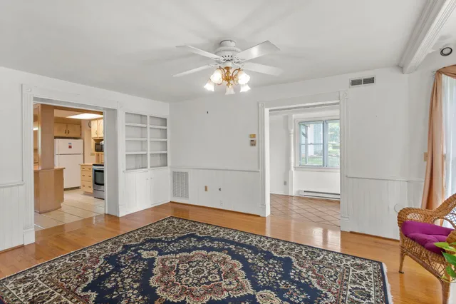 wooden floor with chandelier and closet area