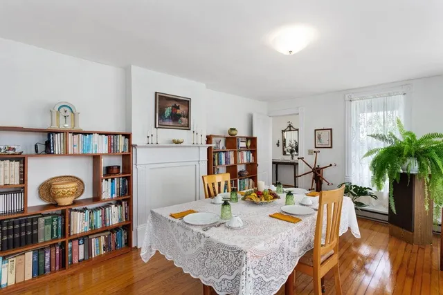 a view of a dining room with furniture and a bookshelf