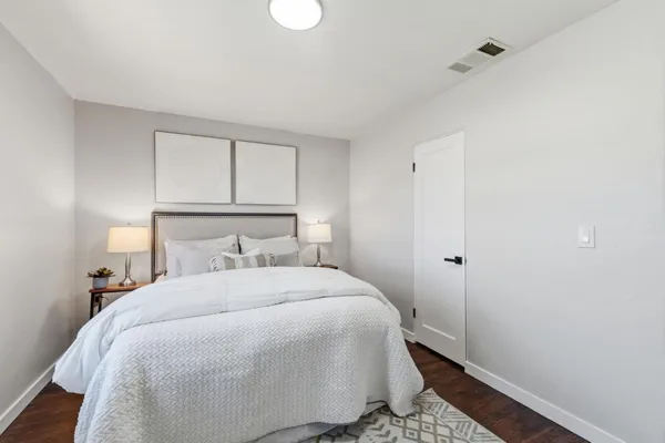 a bedroom with a bed and a couch
