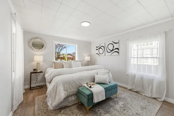 a bedroom with a bed and a window