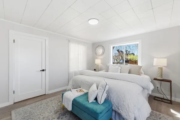 a bedroom with a bed and a window