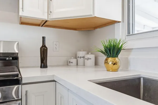 a kitchen with a sink cabinets and stainless steel appliances