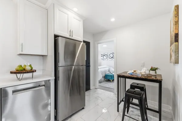 a kitchen with a stove top oven sink and cabinets