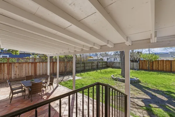 a view of a patio with a table and chairs and potted plants