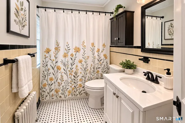 a bathroom with a sink a toilet and shower curtain