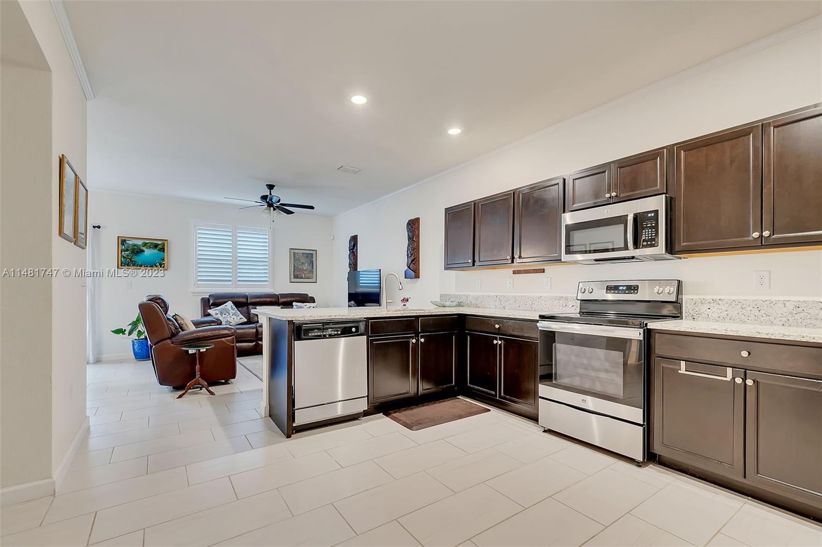 15073 Southwest 119TH Lane Miami, FL 33196 - Photo 12 of 25 a kitchen with cabinets a sink and white appliances