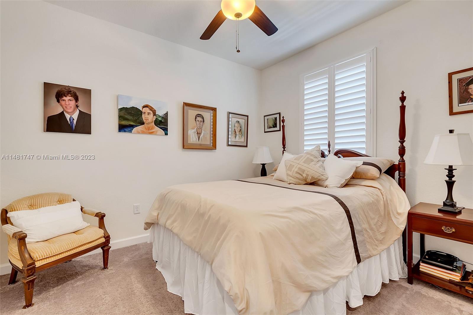 15073 Southwest 119TH Lane Miami, FL 33196 - Photo 19 of 25 a bedroom with a bed and a chandelier