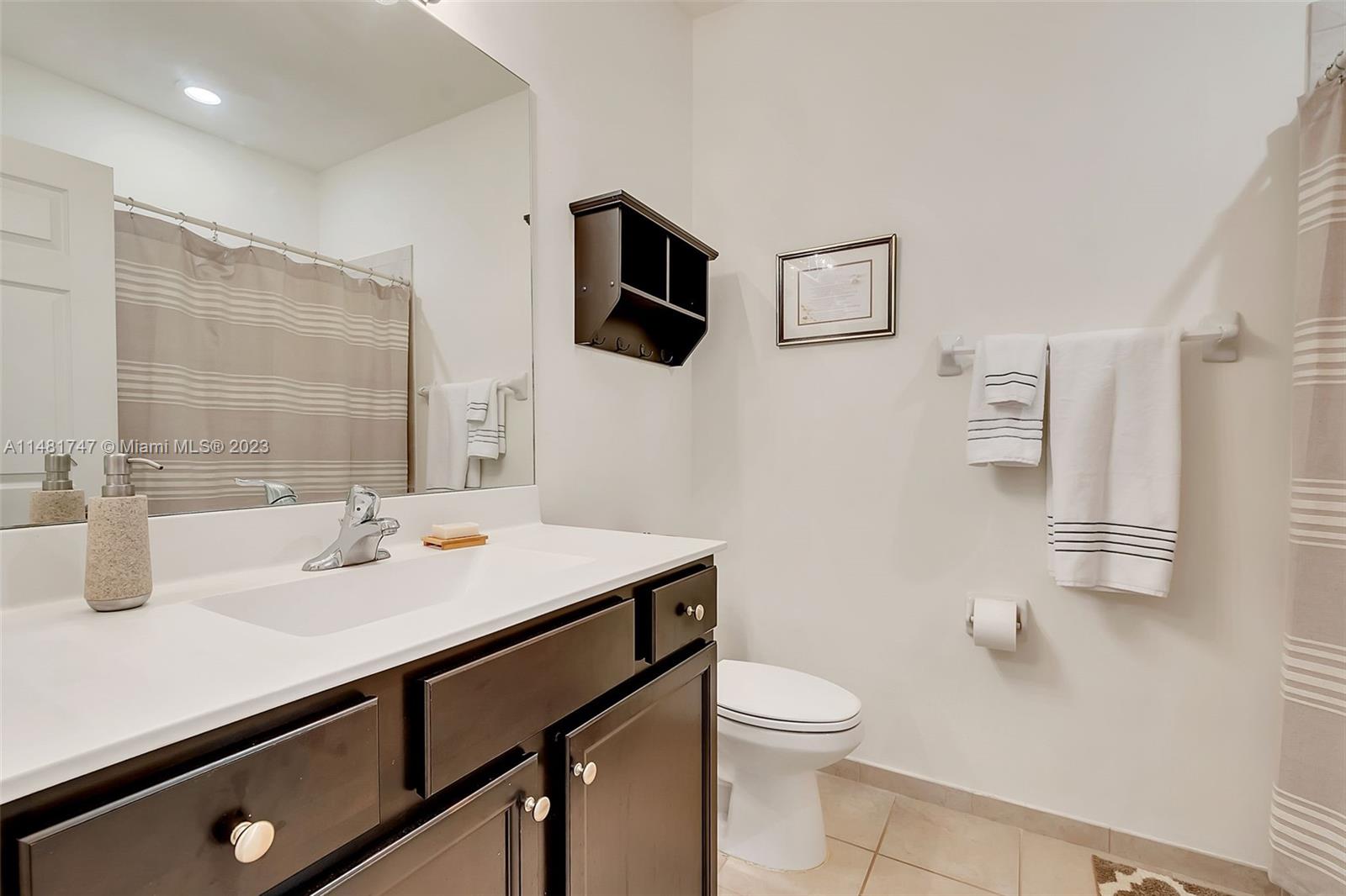 15073 Southwest 119TH Lane Miami, FL 33196 - Photo 20 of 25 a bathroom with a sink a toilet a mirror and shower