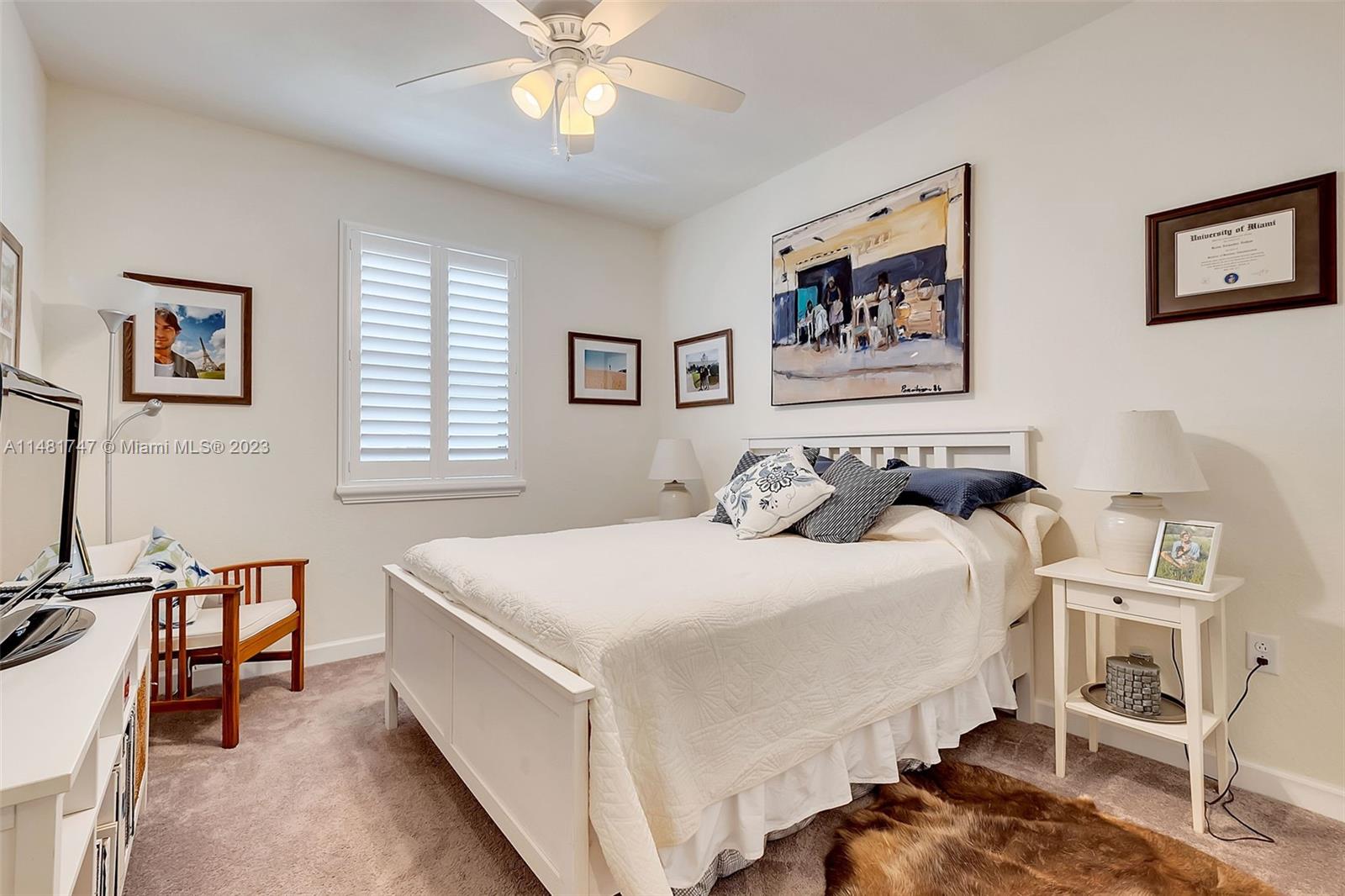 15073 Southwest 119TH Lane Miami, FL 33196 - Photo 21 of 25 a bedroom with a bed and a table in it