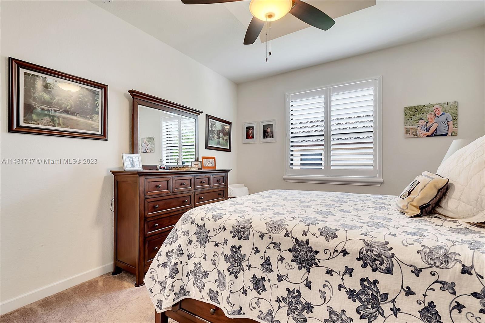 15073 Southwest 119TH Lane Miami, FL 33196 - Photo 23 of 25 a bedroom with a bed and a chandelier