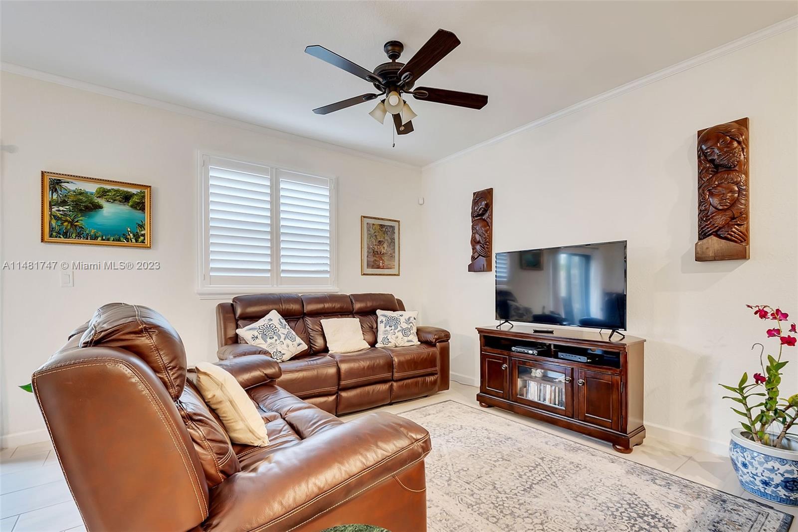 15073 Southwest 119TH Lane Miami, FL 33196 - Photo 4 of 25 a living room with furniture and a flat screen tv