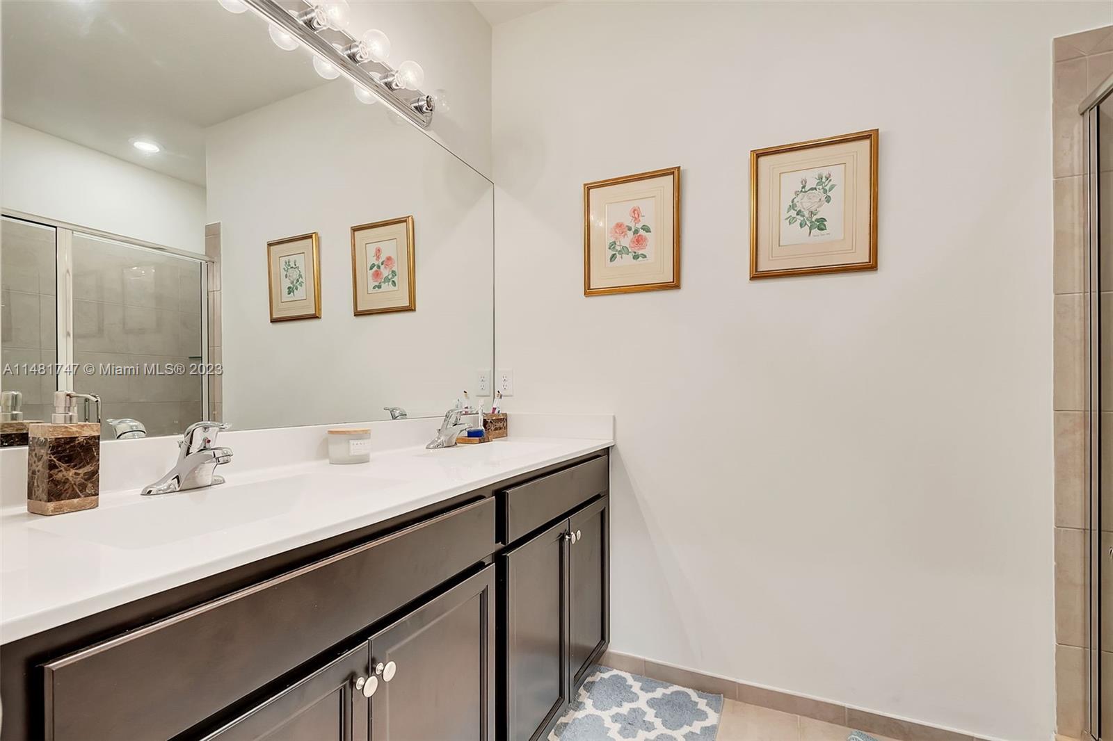 15073 Southwest 119TH Lane Miami, FL 33196 - Photo 7 of 25 a bathroom with a sink and a mirror