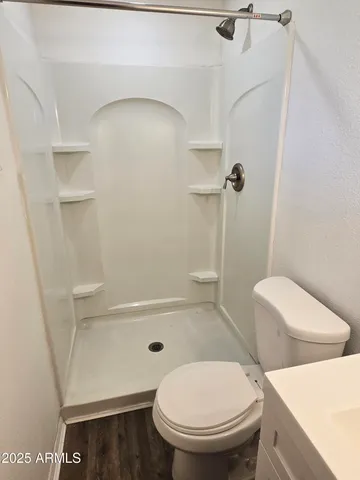 a white toilet sitting next to a bath tub