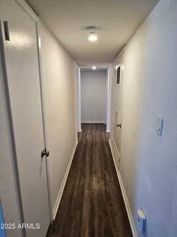 a view of a hallway with wooden floor