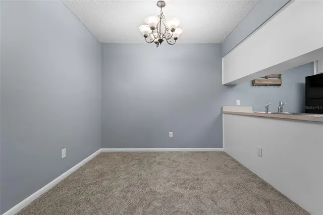 a view of a kitchen with an empty space and a window