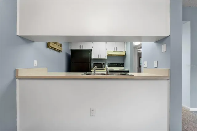 a kitchen with stainless steel appliances a sink and a refrigerator