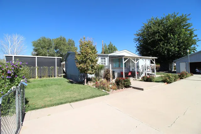 a patio with a table and chairs under an umbrella