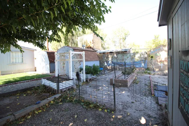 a view of a chair and table in backyard