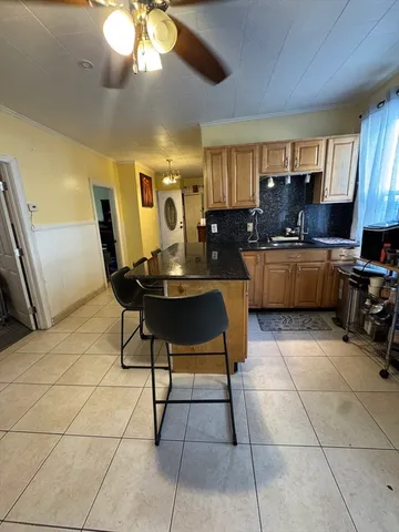 a kitchen with a dining table and chairs
