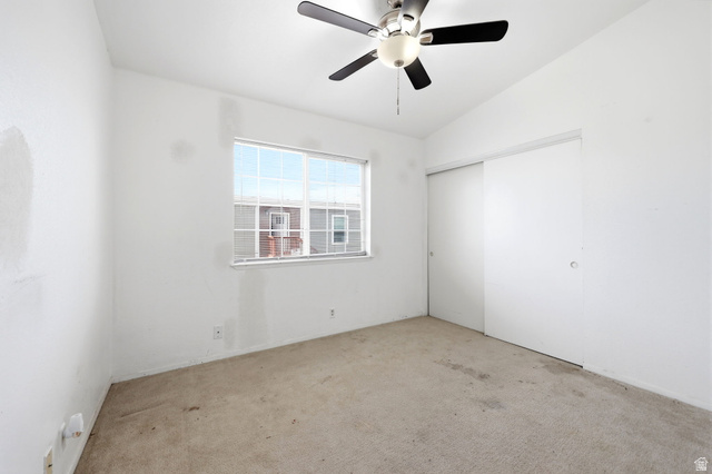 2491 Highway 89, Unit 614 Pleasant View, UT 84404 - Photo 13 of 27 Room featuring a ceiling fan with integrated lighting, a window with white framing, and a sliding closet door