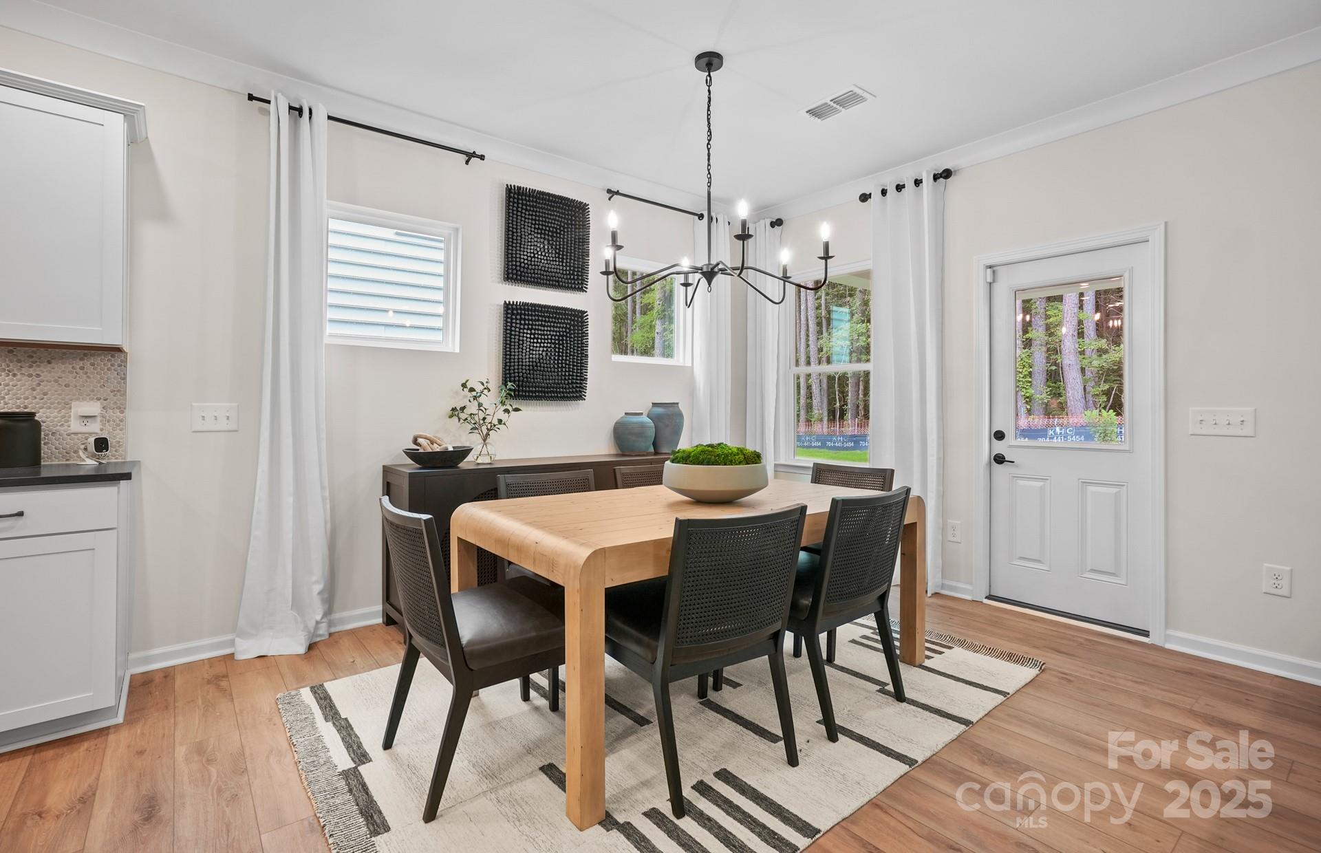 12016 Rails Court, Unit 516 Charlotte, NC 28278 - Photo 12 of 39 a view of a dining room with furniture window and wooden floor