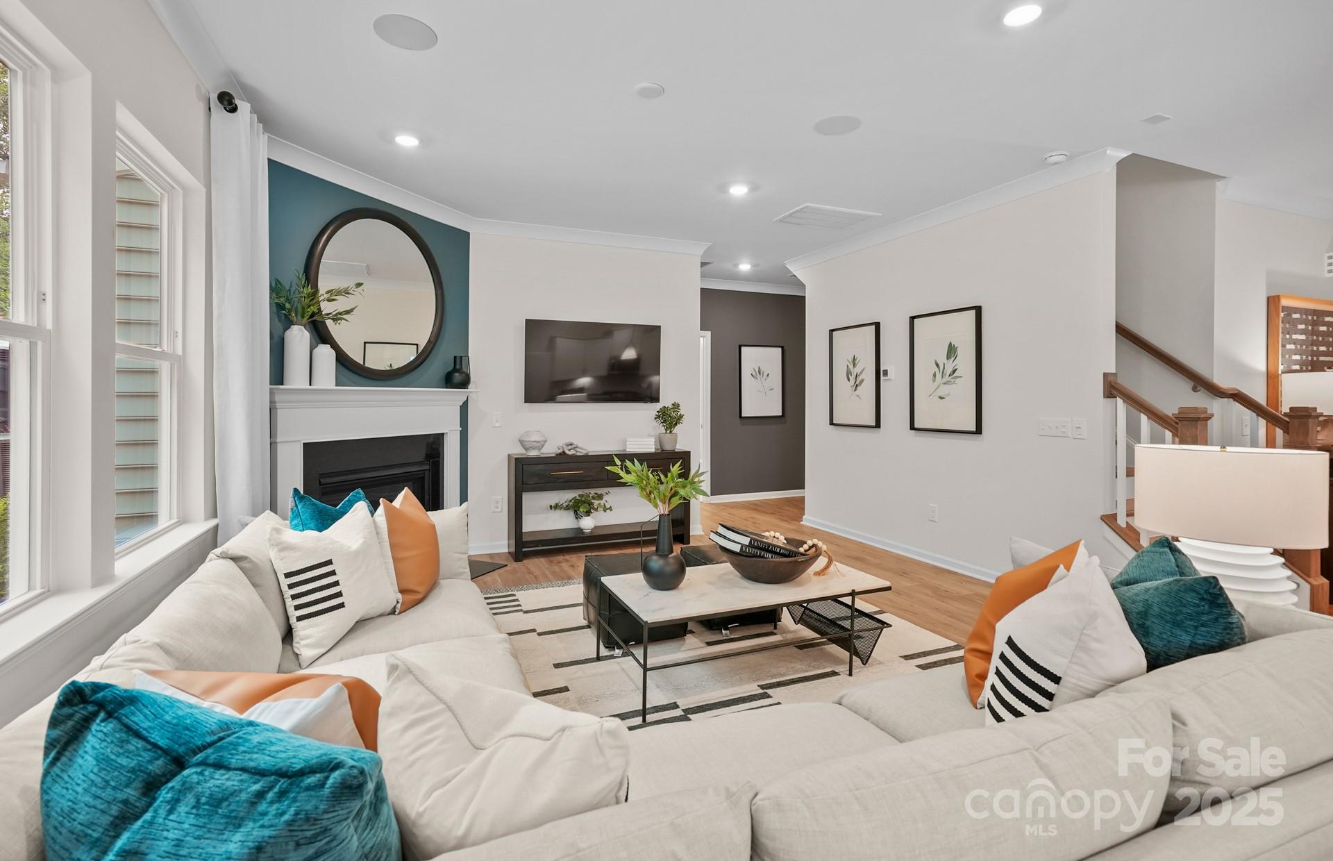 12016 Rails Court, Unit 516 Charlotte, NC 28278 - Photo 13 of 39 a living room with furniture a fireplace and a flat screen tv