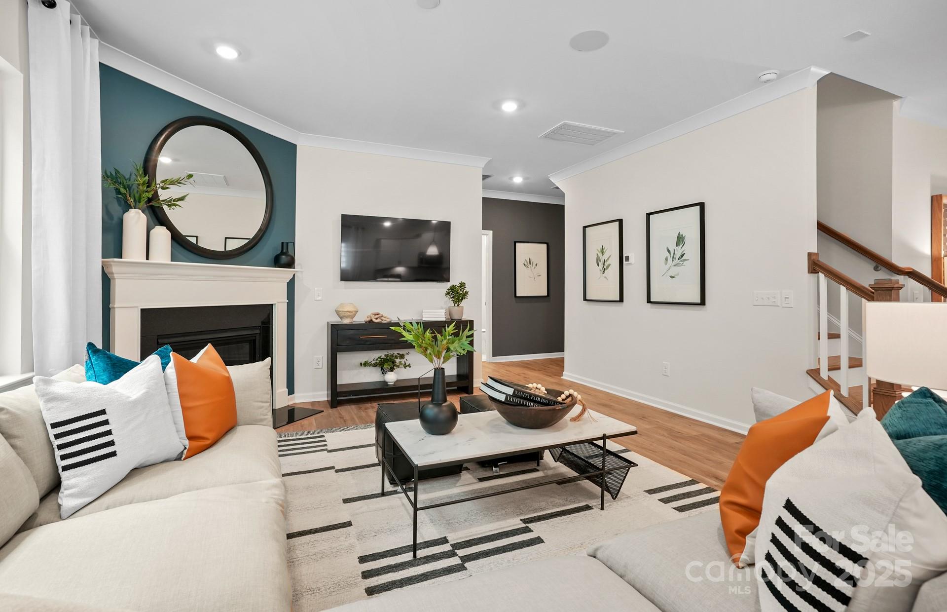 12016 Rails Court, Unit 516 Charlotte, NC 28278 - Photo 14 of 39 a living room with furniture a clock and a fireplace