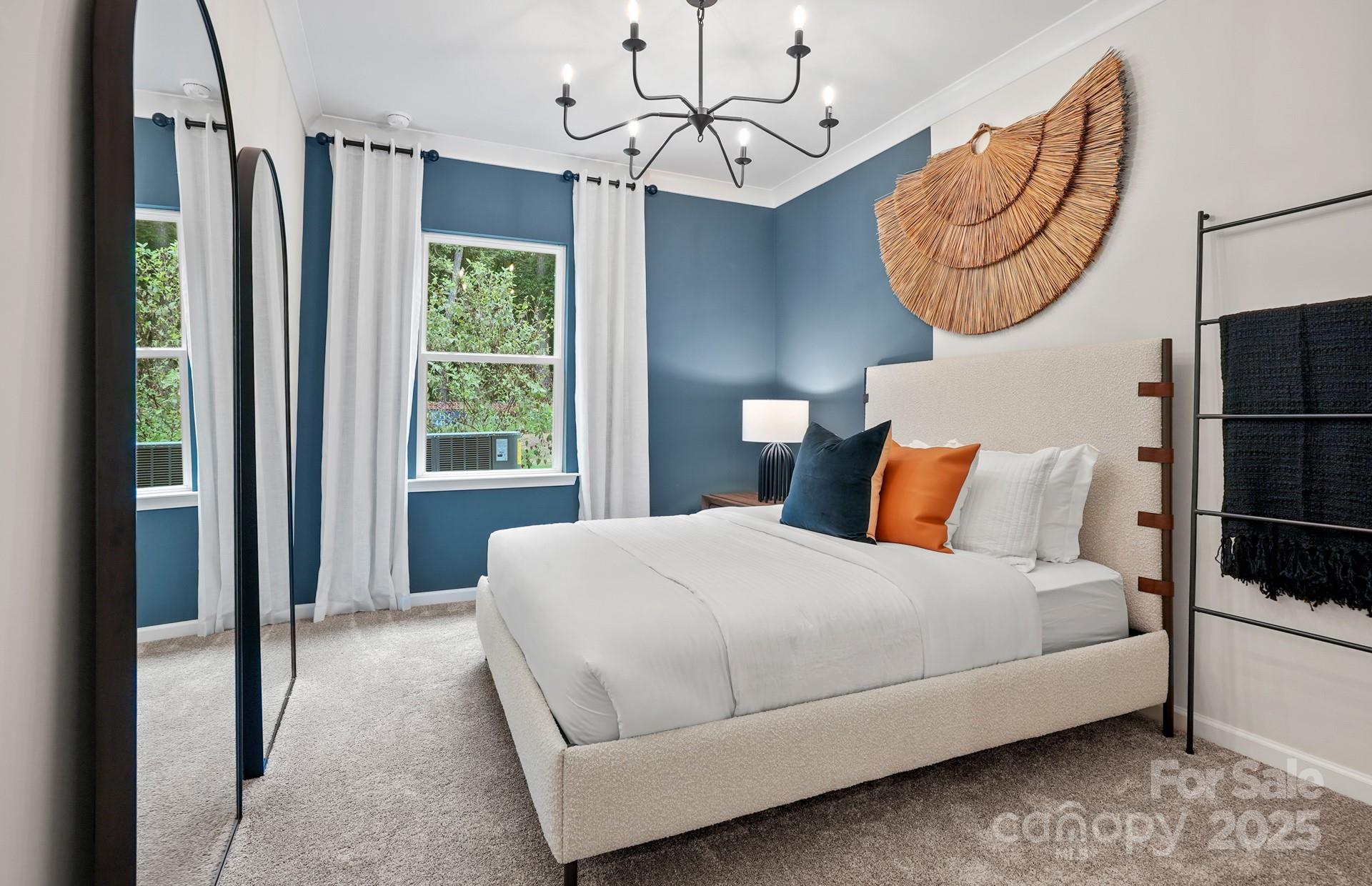 12016 Rails Court, Unit 516 Charlotte, NC 28278 - Photo 20 of 39 a bedroom with a large bed and a chandelier