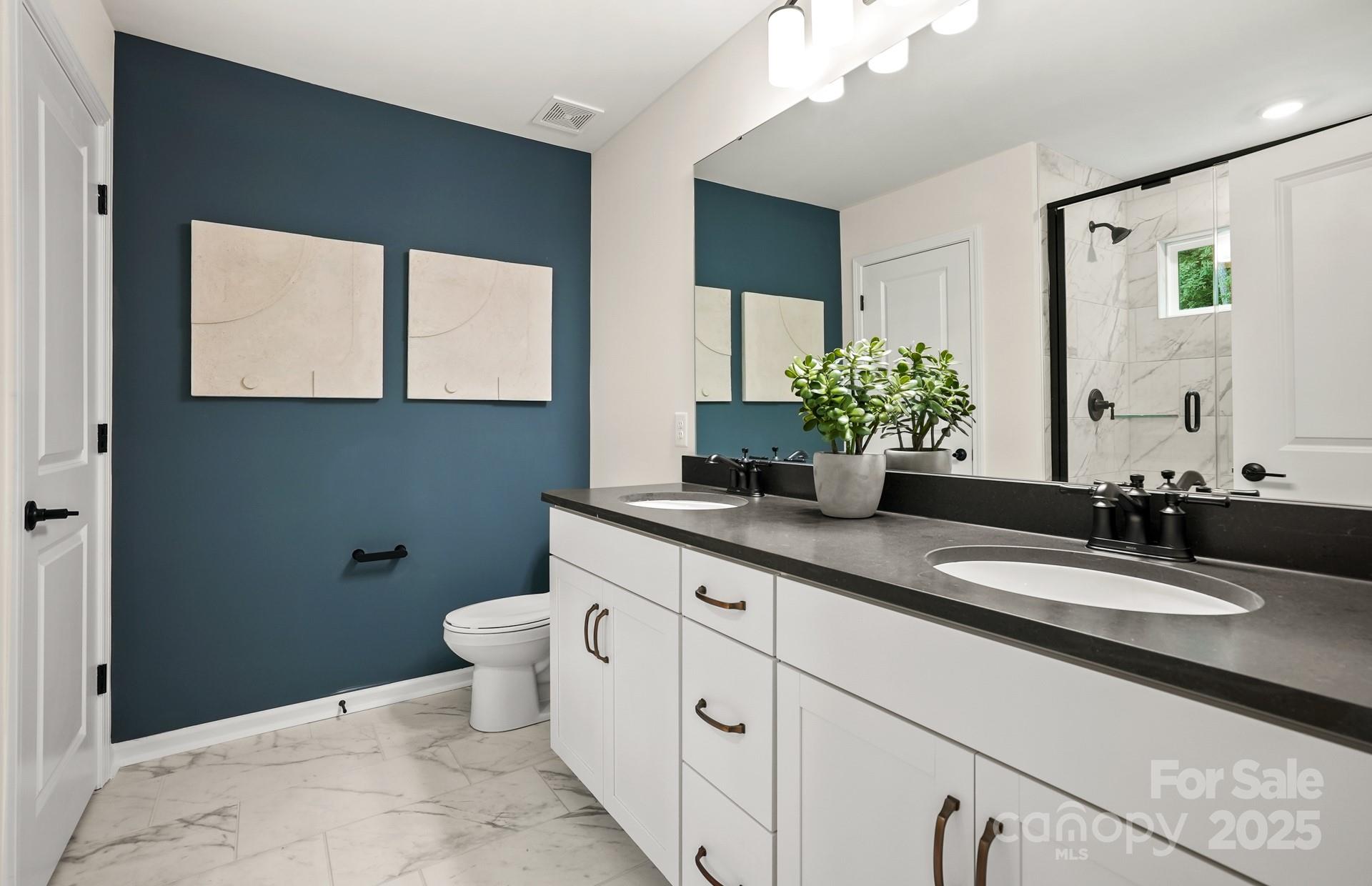 12016 Rails Court, Unit 516 Charlotte, NC 28278 - Photo 29 of 39 a bathroom with a toilet sink and mirror