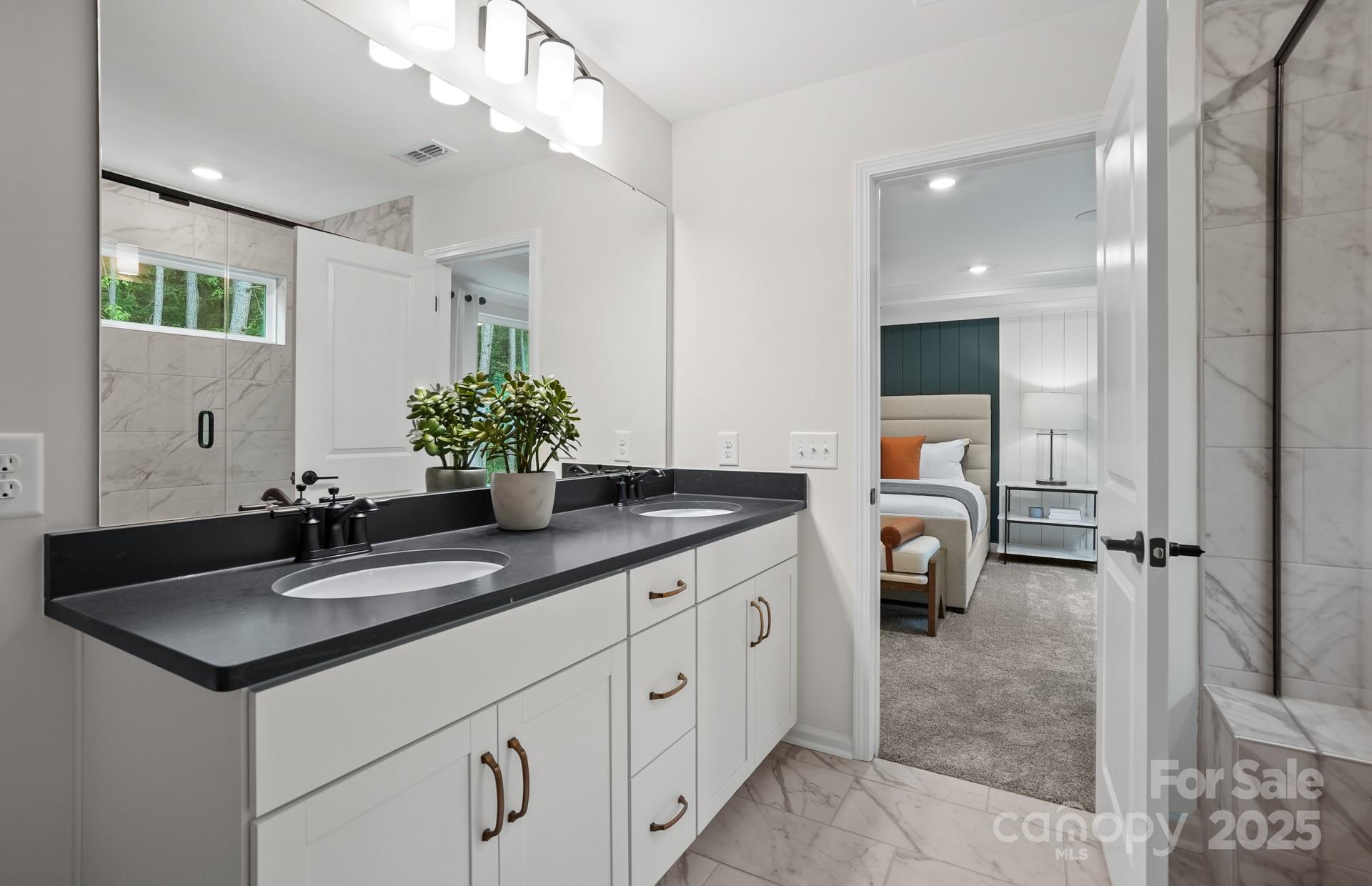 12016 Rails Court, Unit 516 Charlotte, NC 28278 - Photo 30 of 39 a spacious bathroom with a double vanity sink mirror and