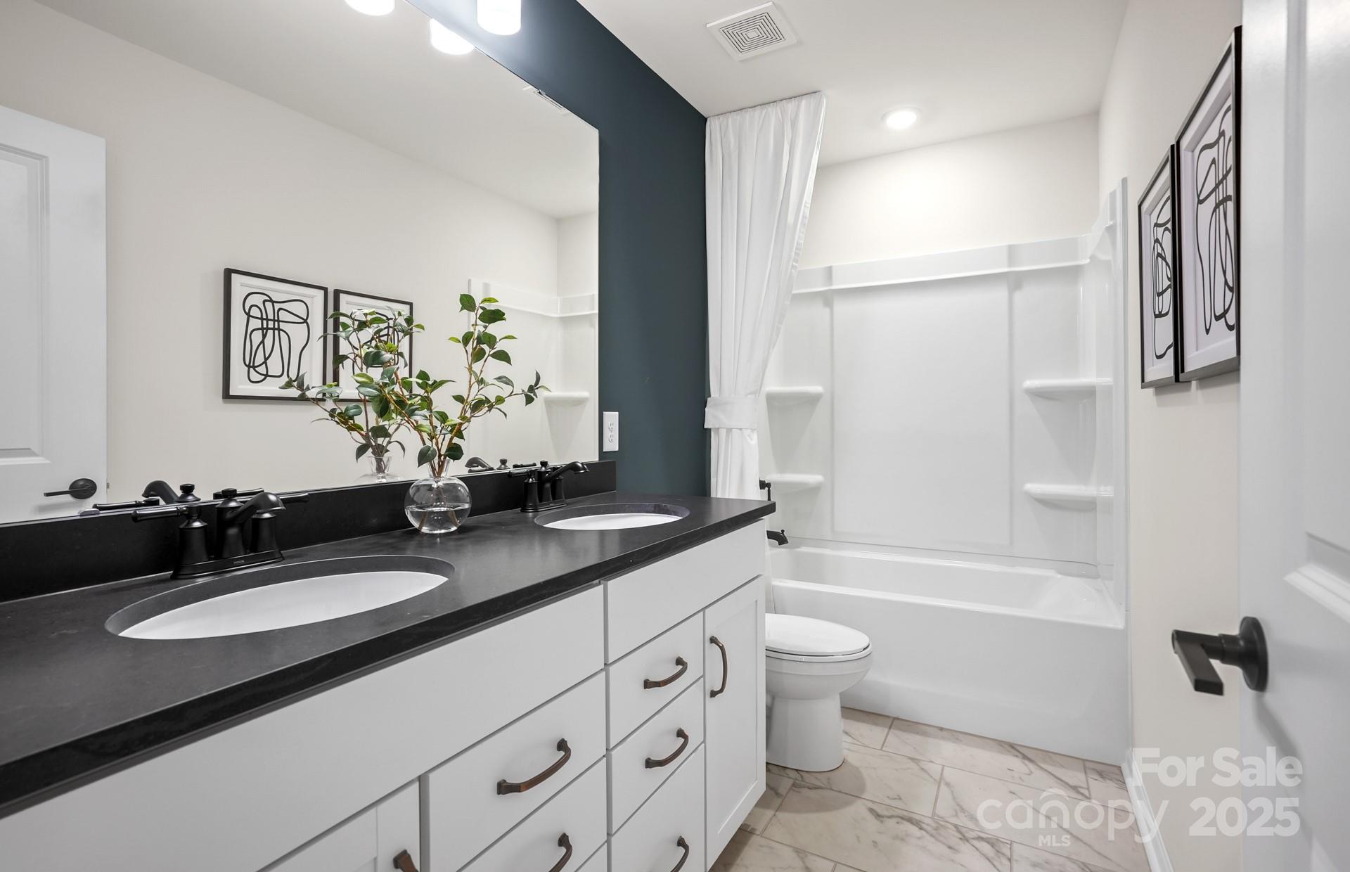 12016 Rails Court, Unit 516 Charlotte, NC 28278 - Photo 38 of 39 a bathroom with a granite countertop sink toilet and shower
