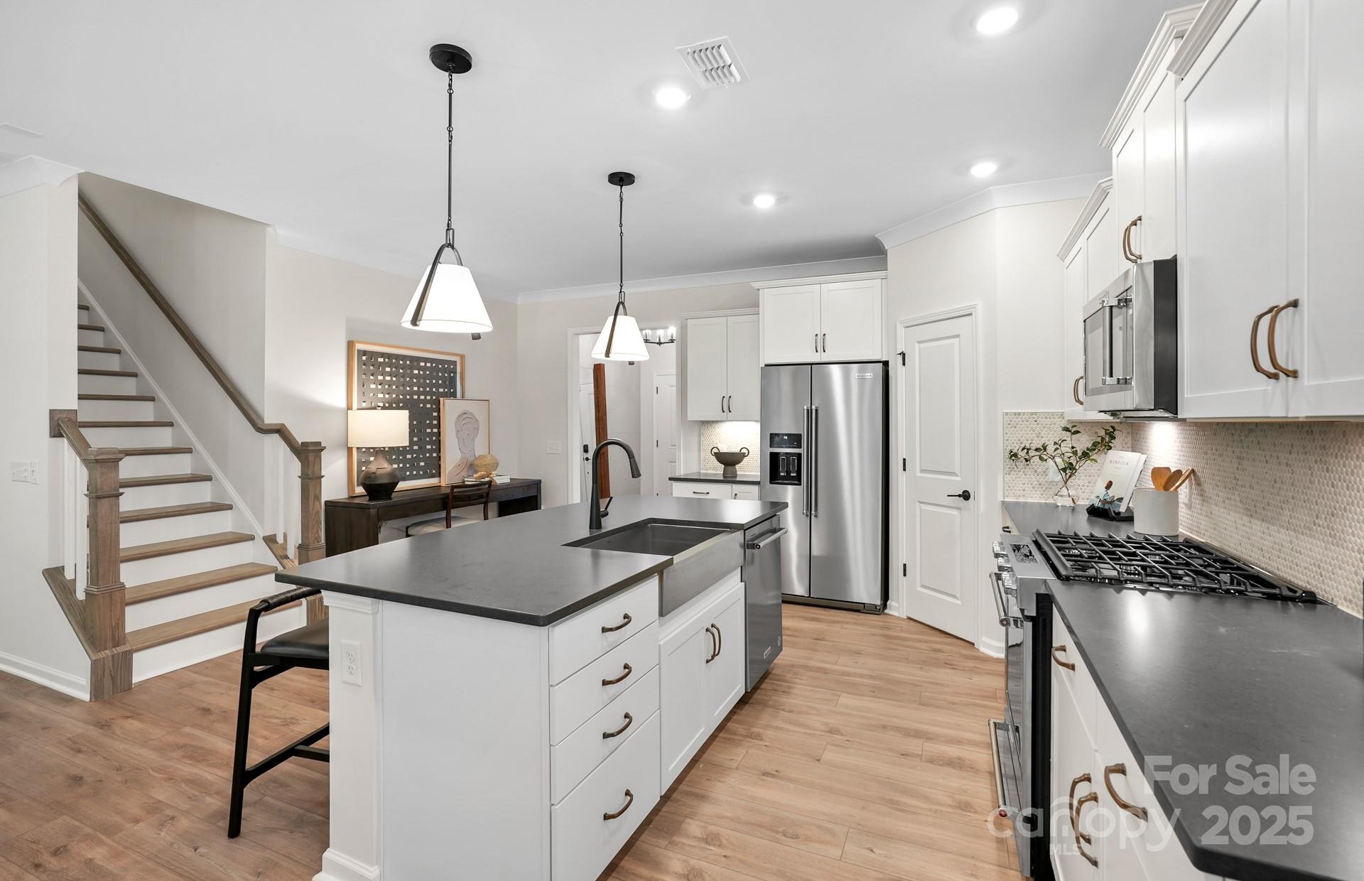 12016 Rails Court, Unit 516 Charlotte, NC 28278 - Photo 6 of 39 a kitchen with stainless steel appliances granite countertop a sink a stove and a refrigerator