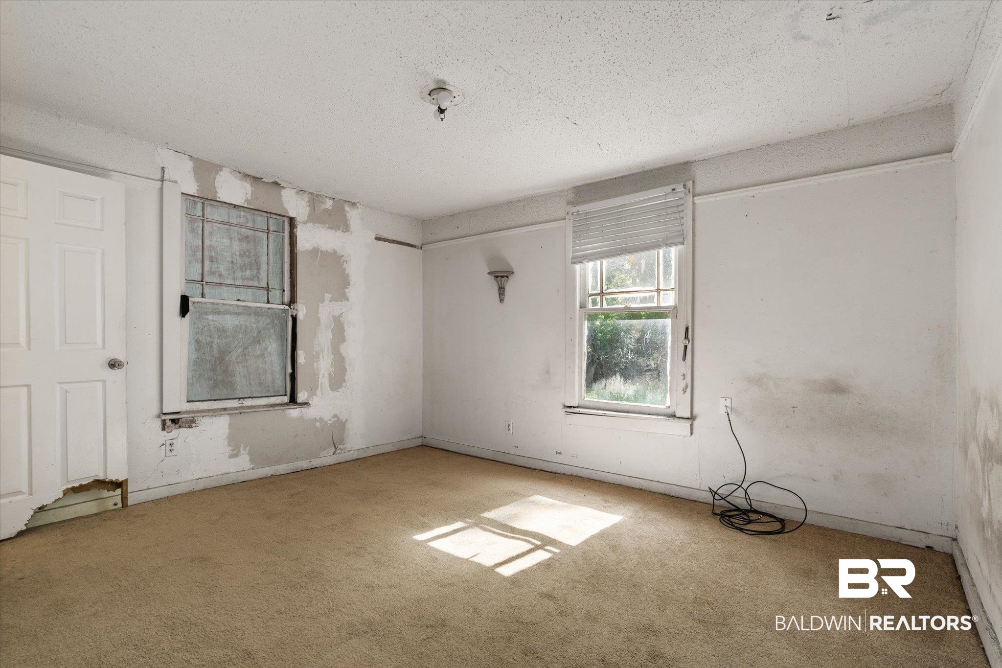 672 Burden Street Mobile, AL 36607 - Photo 10 of 20 Empty room with carpet floors and a textured ceiling