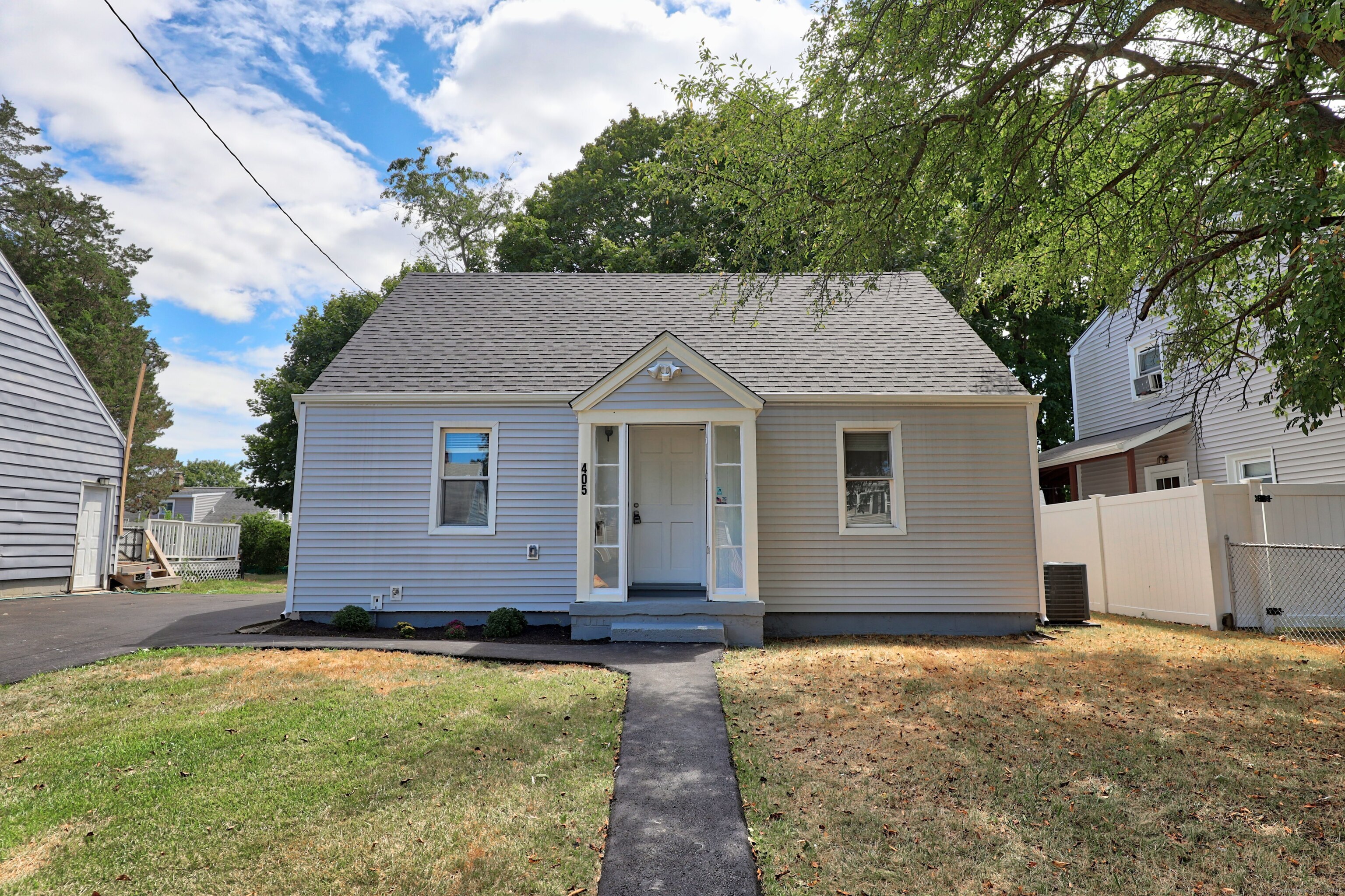 405 Ruth Street Bridgeport, CT 06606 - Photo 1 of 1 a front view of a house with a yard and garage