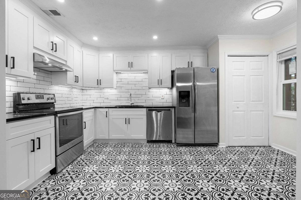 365 Winding River Drive Atlanta, GA 30350 - Photo 1 of 34 a kitchen with stainless steel appliances granite countertop a refrigerator sink and cabinets