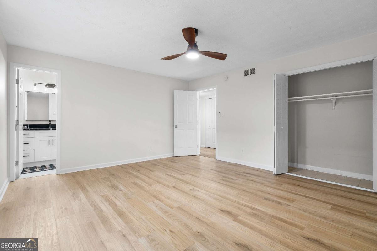 365 Winding River Drive Atlanta, GA 30350 - Photo 22 of 34 a view of empty room with wooden floor and ceiling fan