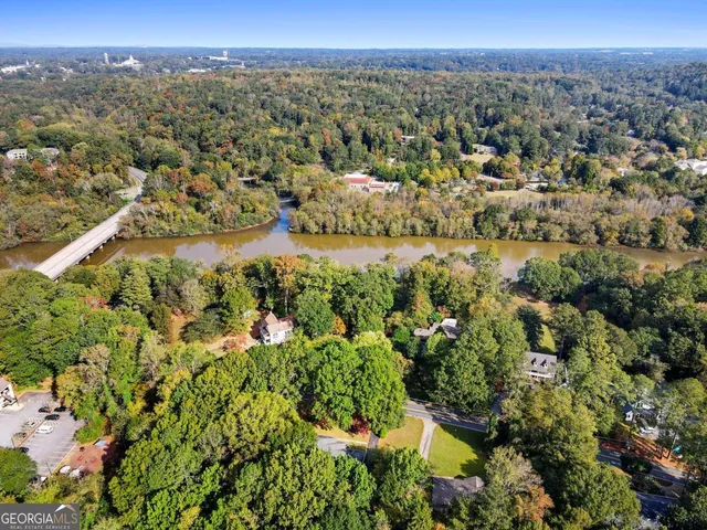 an aerial view of a swimming pool with lounge chairs