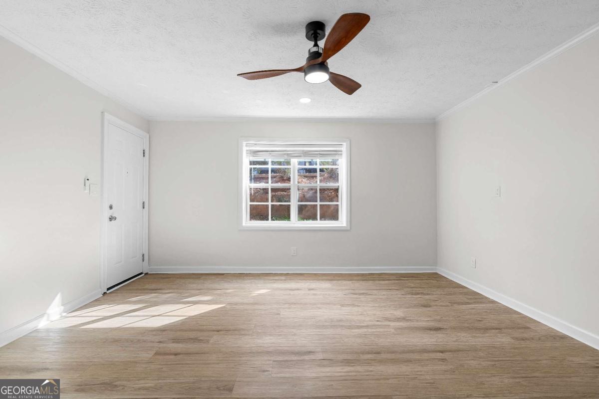 365 Winding River Drive Atlanta, GA 30350 - Photo 7 of 34 a view of empty room with wooden floor and window
